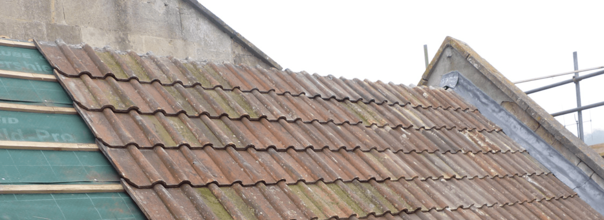 Roof repair and installation of new roof felt and treated battens on a roof in Bath before reclaimed clay double roman tiles were re-fitted by Robinson Building and Roofing Specialists.