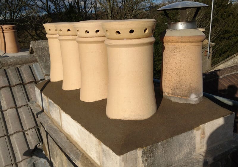 Roof Repair on Bath Stone Chimney on a roof in Bath by Robinsons Building and Roofing, New Buff chimney pots and ventilations cowls also installed. Roofing in Bath