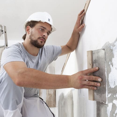 Builder plastering wall