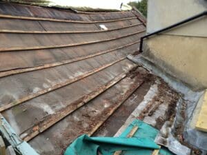 Old Bitumen felt and rotten roofing timbers prior to roof restoration by out roofers at Robinson's Roofing in Bath.